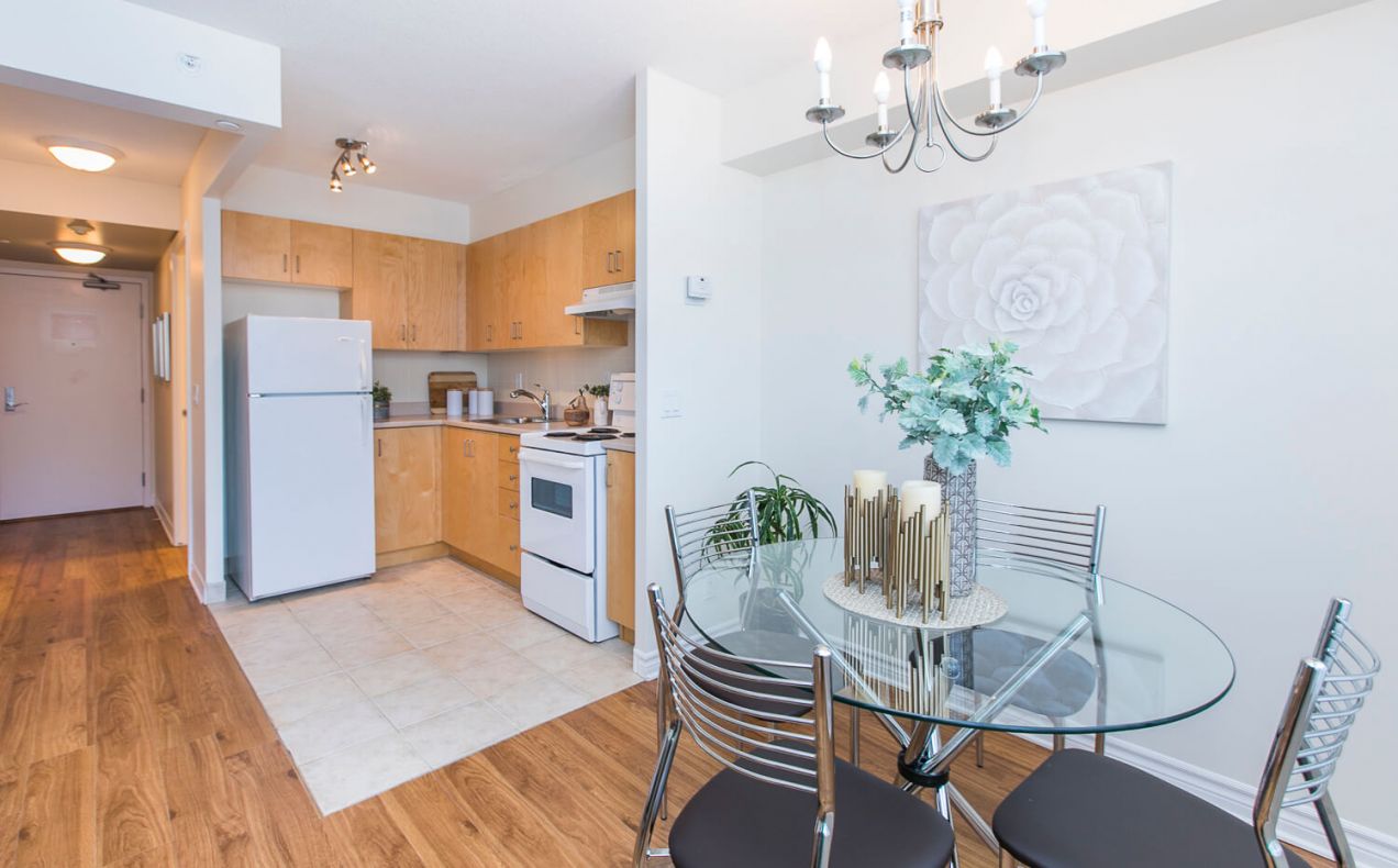 Bright open concept dining area and kitchen in apartment at 100 Isabella