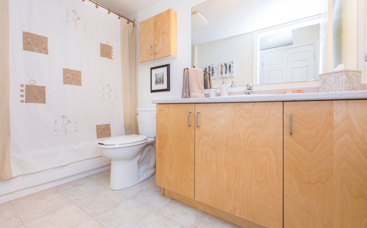 Clean bathroom with shower in a bachelor/studio apartment